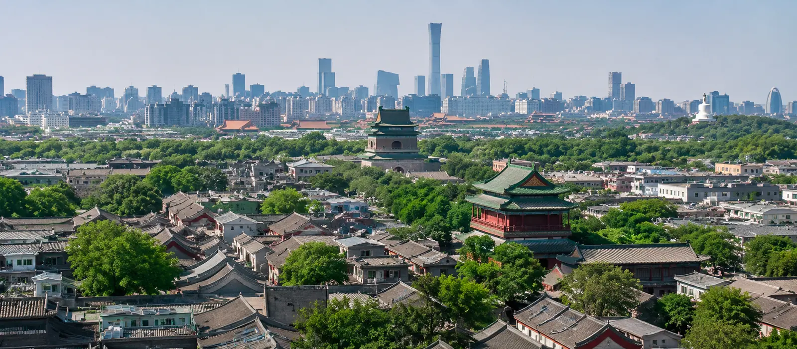 View across Beijing featuring the Forbidden City, modern skyline, and traditional architecture, representing the city\'s blend of history and contemporary China.